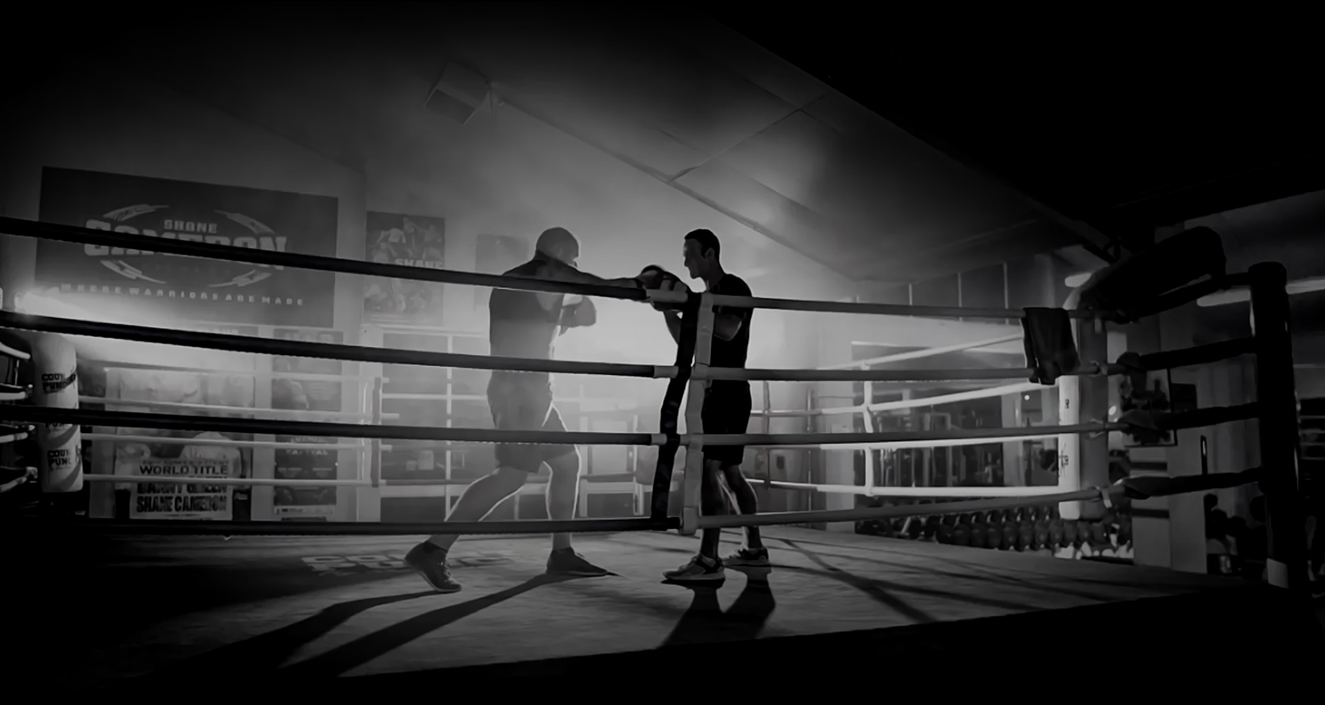 Two boxers duking it out in a boxing ring - monochrome
