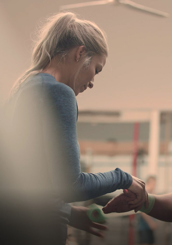 Woman applying d3 tape to another persons wrist